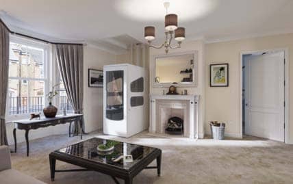 VE enclosed through-floor home lift installed in a living room